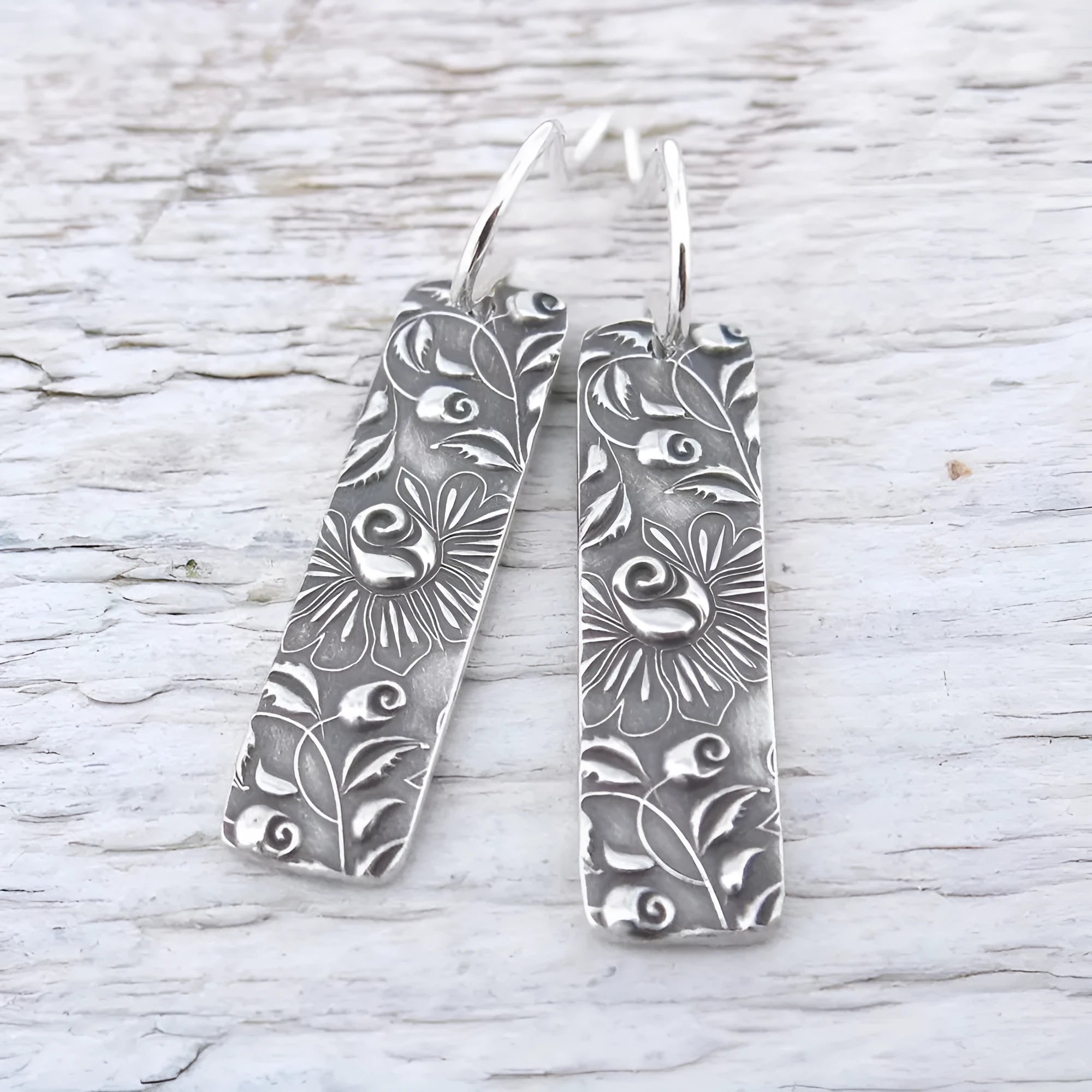 Silver geometric long earrings with a carved vine pattern in a retro style