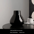 Ceramic round belly vase with coloured glaze finish and two orchid flowers in modern simplicity design