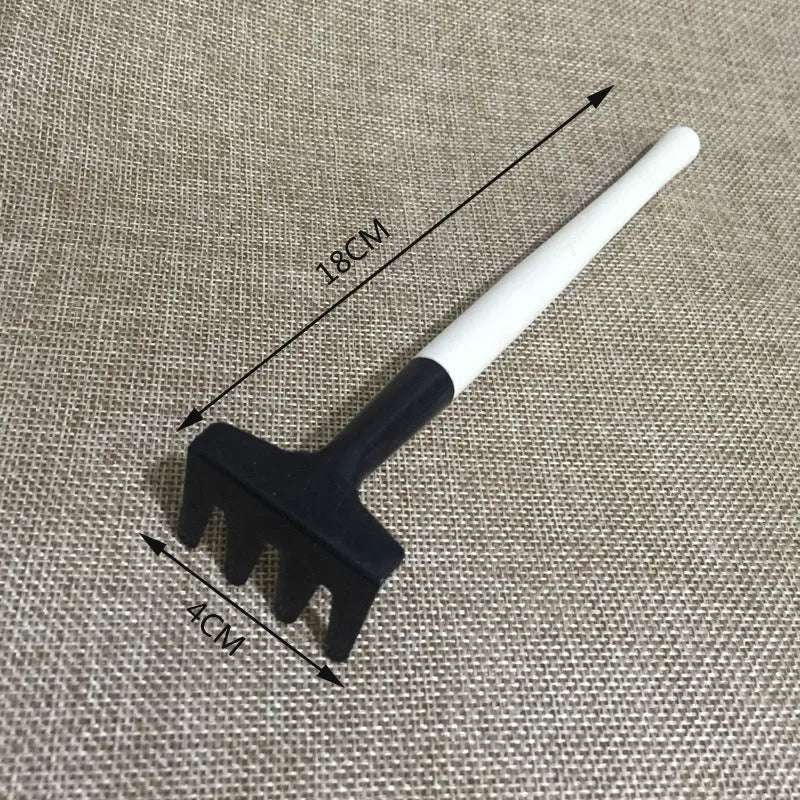 Succulent gardening tool set showing drip kettle, tweezers, mini shovel, rake, and other small plant care tools on a table.