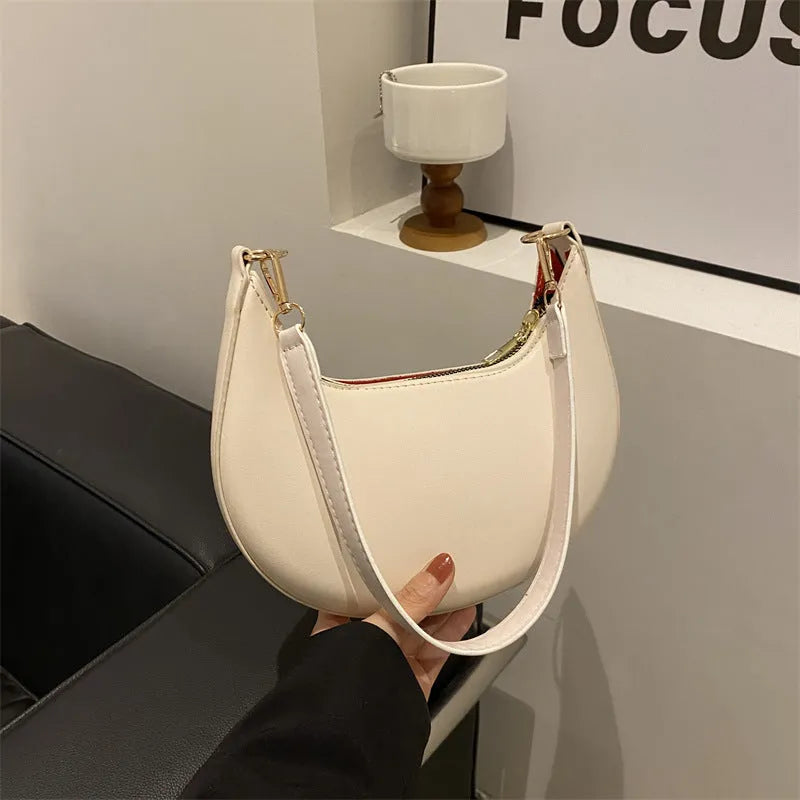 21cm round PU underarm bag with single shoulder strap in seven colour options showing mobile phone pocket