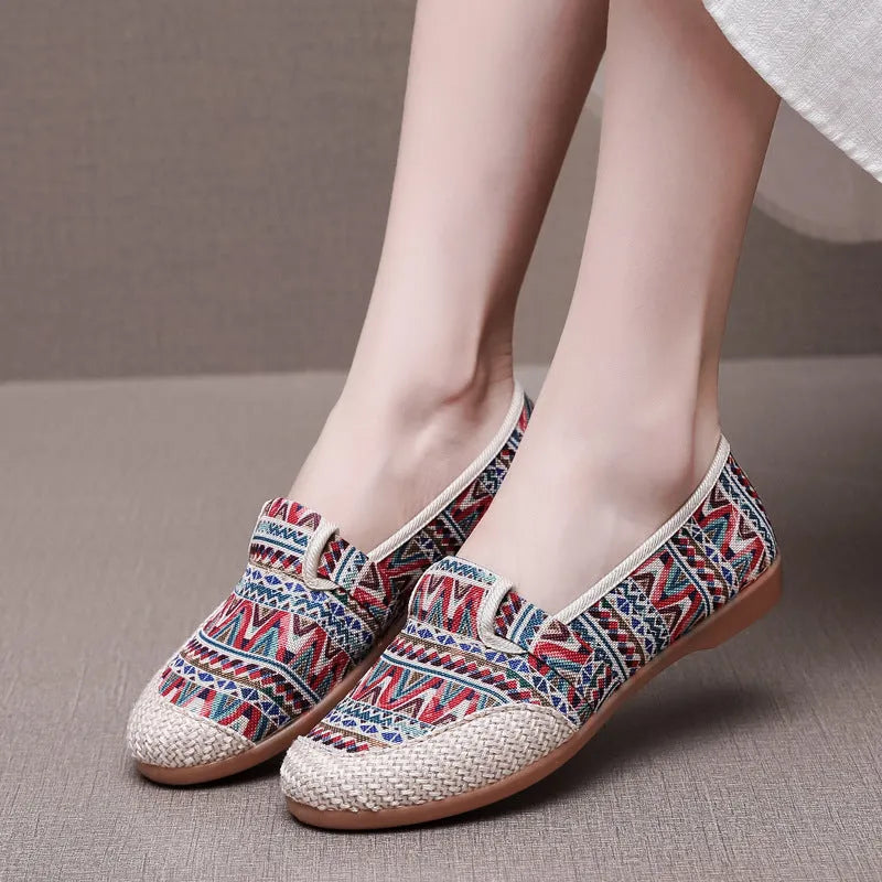 Women's ethnic style flat heel cloth shoes with colour stitching and shallow mouth design.