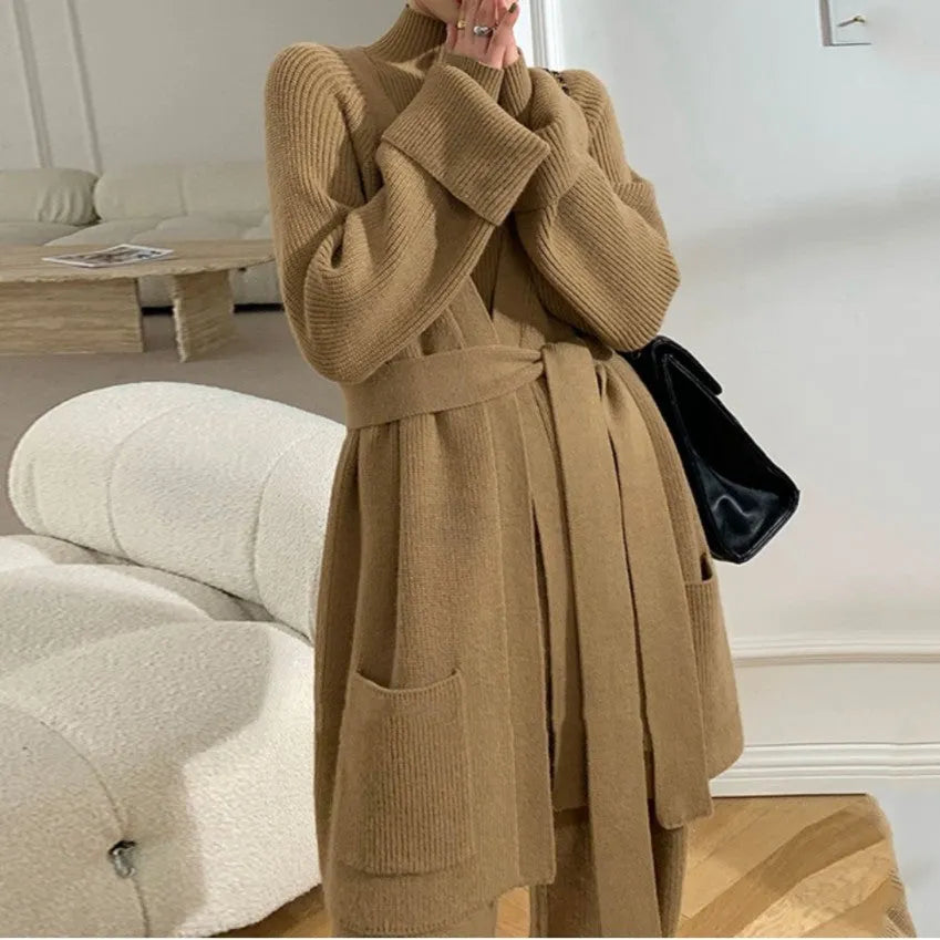 Women's apricot knitted wide-leg pants, sweater, and cardigan three-piece set with leather stitching detail.