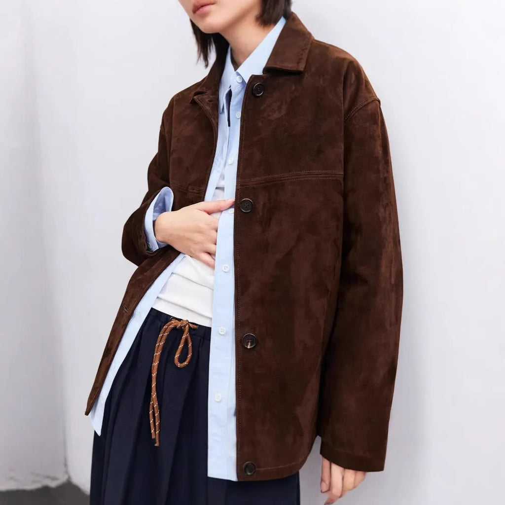 Women's caramel mocha cashmere coat with a peter pan collar and decorative leather stitching.