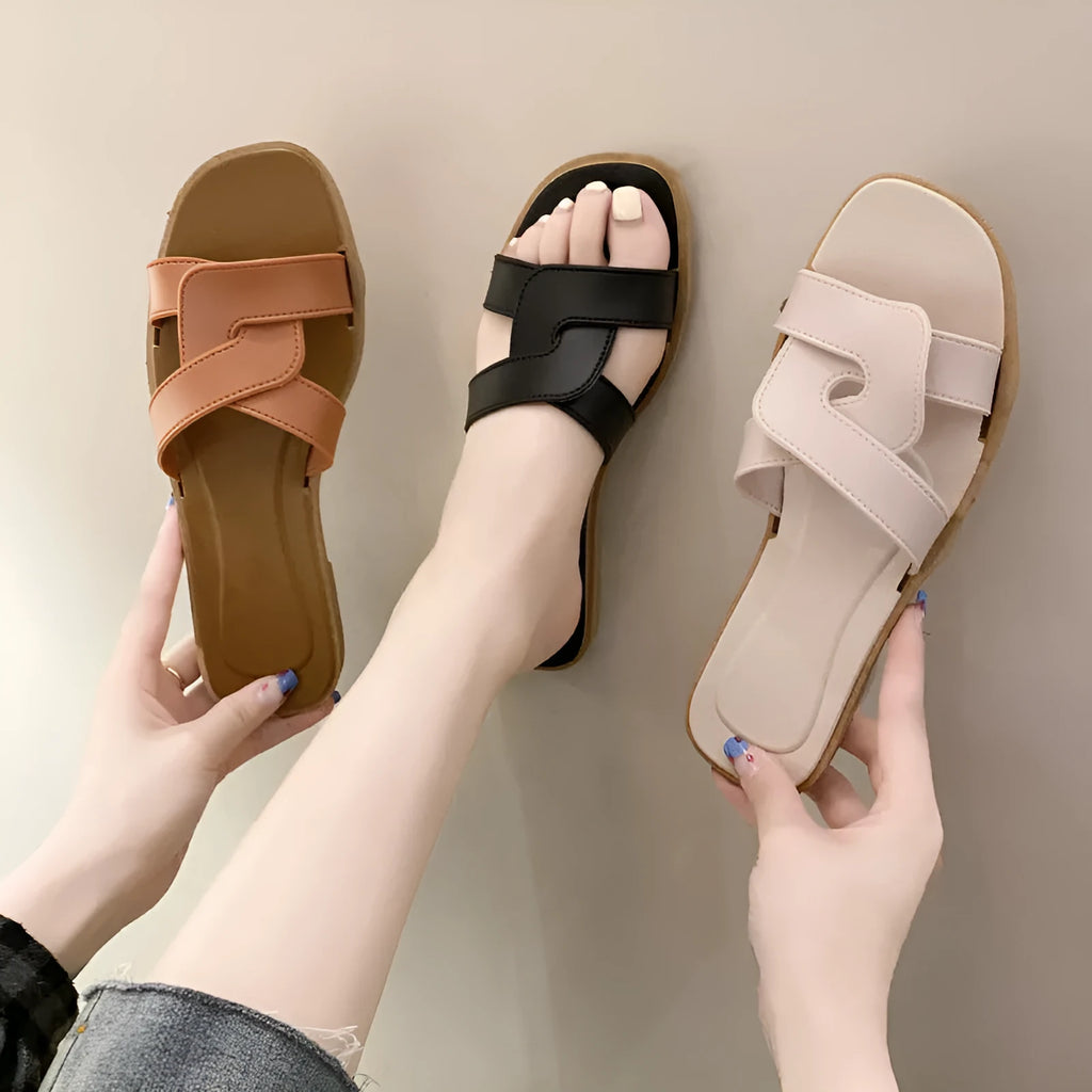 Women's PVC cross-strap toe ring sandals in light blue on a white background.