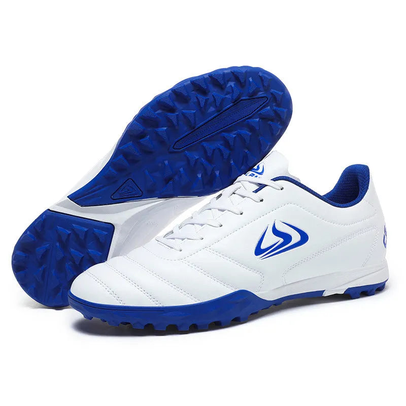 Low top football shoes with synthetic leather upper and rubber sole in black and white broken nails colour.