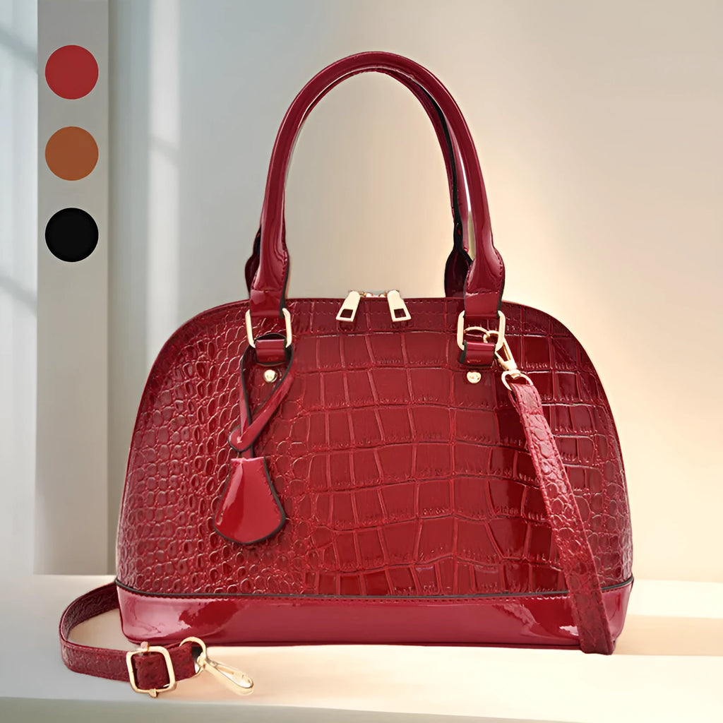 Shiny PU crossbody bag in shell shape measuring 22x30x15cm with polyester lining in black colour