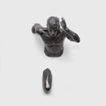 Minimalist metallic resin character sculpture wall hanging in copper finish.