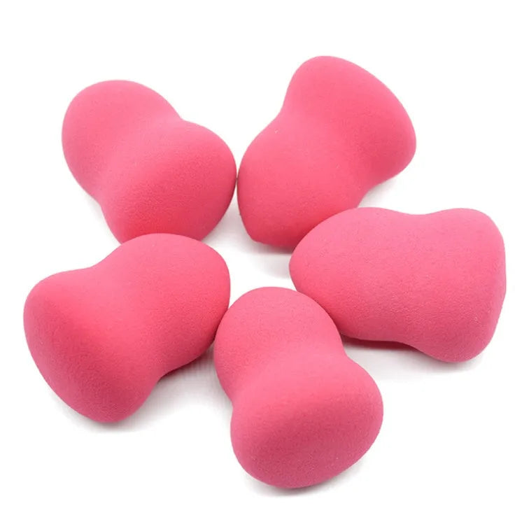 Pink square makeup blending sponge on a white background.