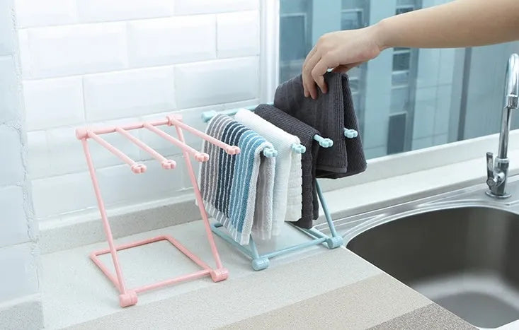 Foldable plastic dishcloth shelf in light blue with bottles stored vertically