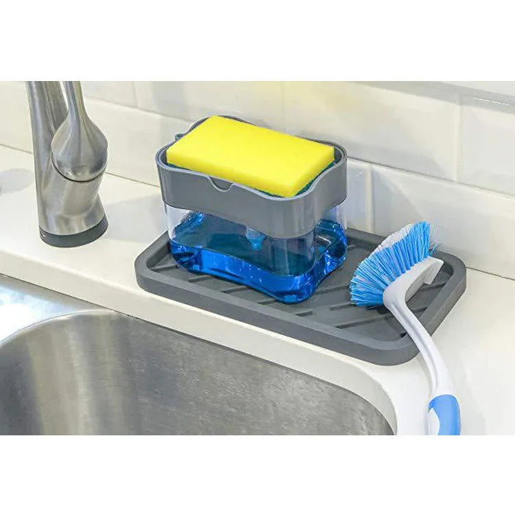 A grey plastic soap dispenser with a pump, sitting on a kitchen countertop.