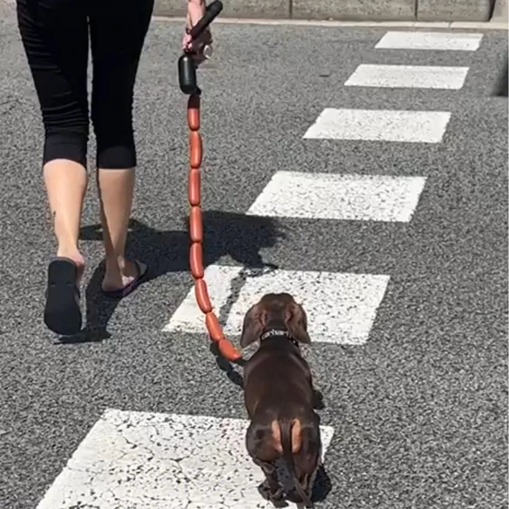Brown sausage chew toy sewn into a 108cm soft rope dog lead with a grip tape section.