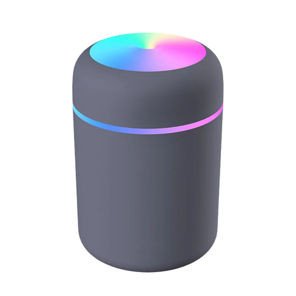 Mini ultrasonic essential oil diffuser with 300ml water tank in white, showing coloured night lights and USB cable