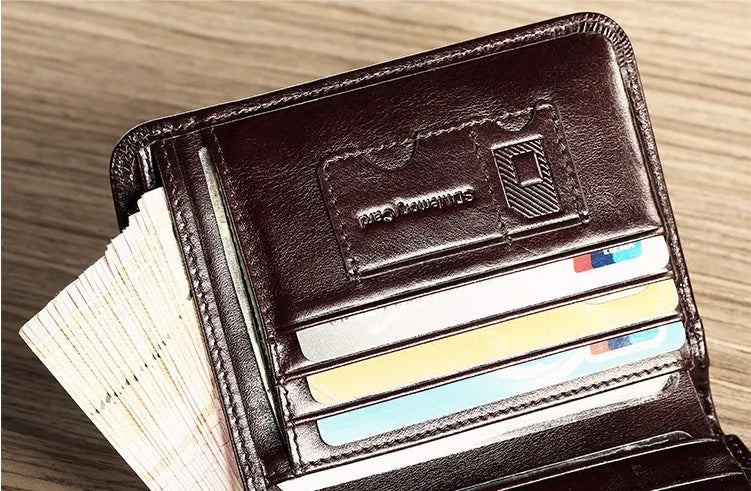 Men's brown leather bifold wallet open to show photo slot, card slots, billfold, and coin pocket.