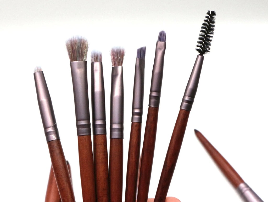 11-piece makeup brush set with synthetic hair heads, matte coffee aluminium ferrules, and natural wood handles