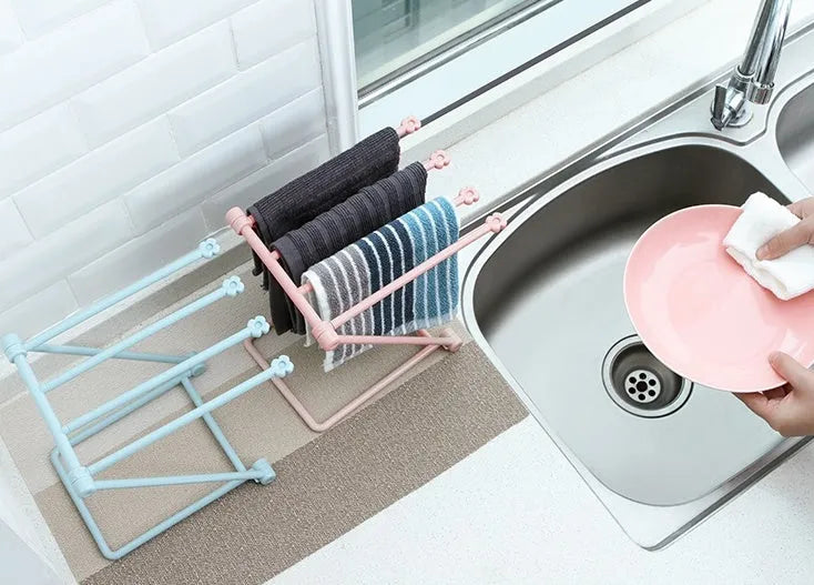 Foldable plastic dishcloth shelf in light blue with bottles stored vertically