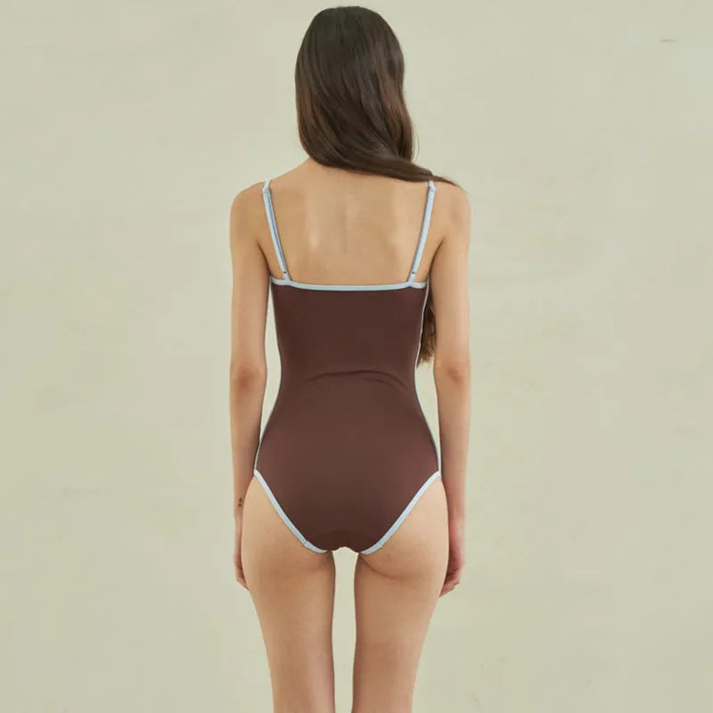 Brown women's one-piece triangle swimsuit showing front design on mannequin