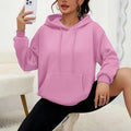 Women's loose fit grey sweatshirt with a drawstring pocket and long sleeves on a hanger.