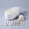 Nordic style multifunctional vegetable slicer in blue, grey, or khaki with stainless steel blades on a kitchen counter.