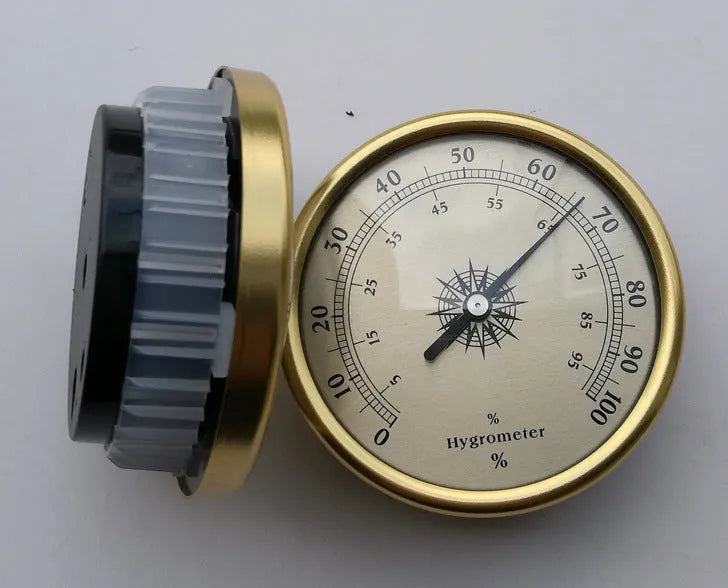 Analog thermometer and hygrometer with silver aluminium ring and dial showing temperature and humidity scales.