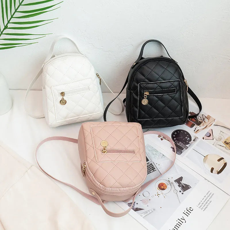 Girls' hard square PU backpack with embroidery in pink, showing front sandwich pocket and carry handle.