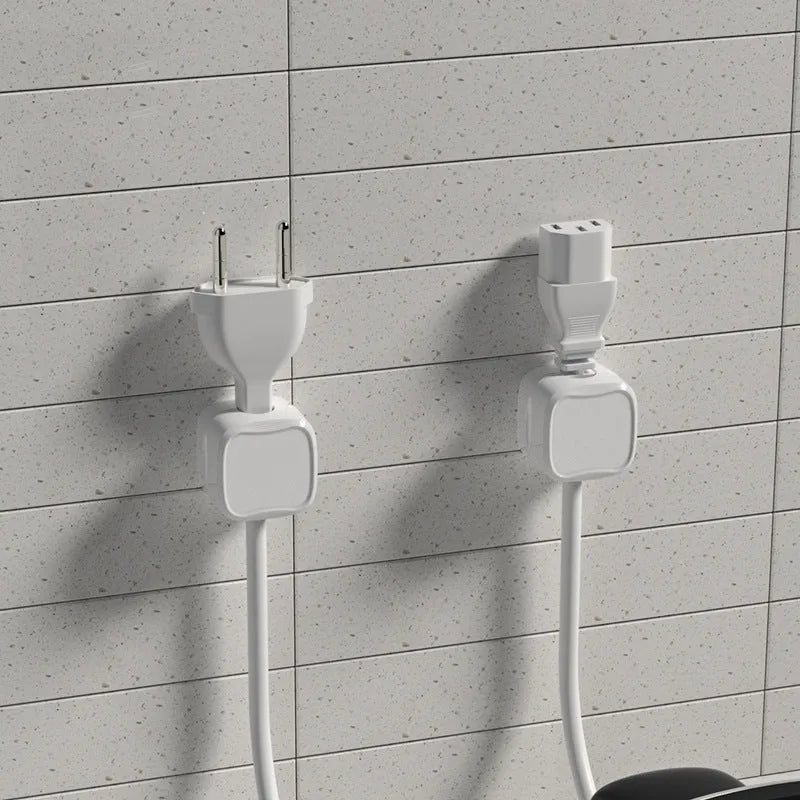 White and black magnetic under-desk cable clips organising various cables with adhesive backing
