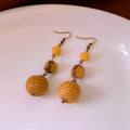 Brown resin fruit core tassel earrings with round geometric design and ear hook clasp for women