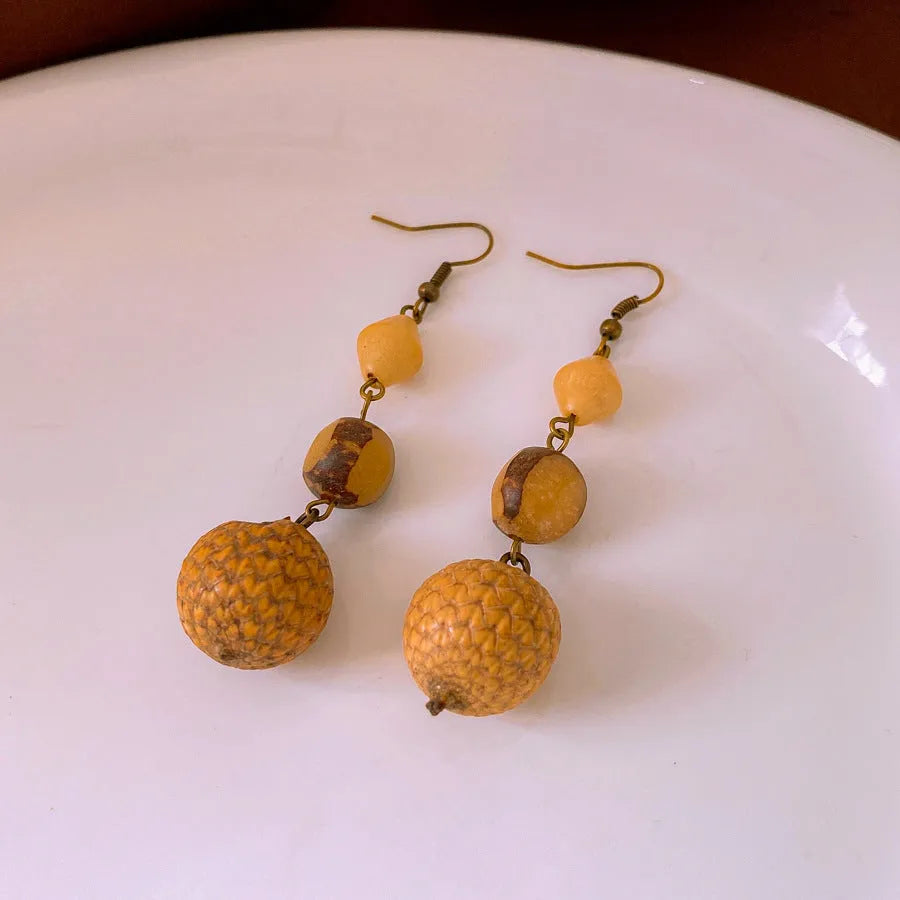 Brown resin fruit core tassel earrings with round geometric design and ear hook clasp for women