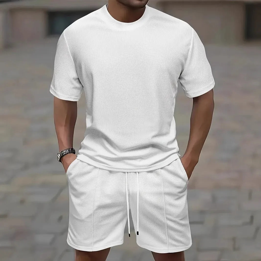 Man wearing a white waffle texture short sleeve blouse and matching shorts summer set.