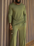 Men's green polyester casual set with long sleeve top and full-length trousers on hanger
