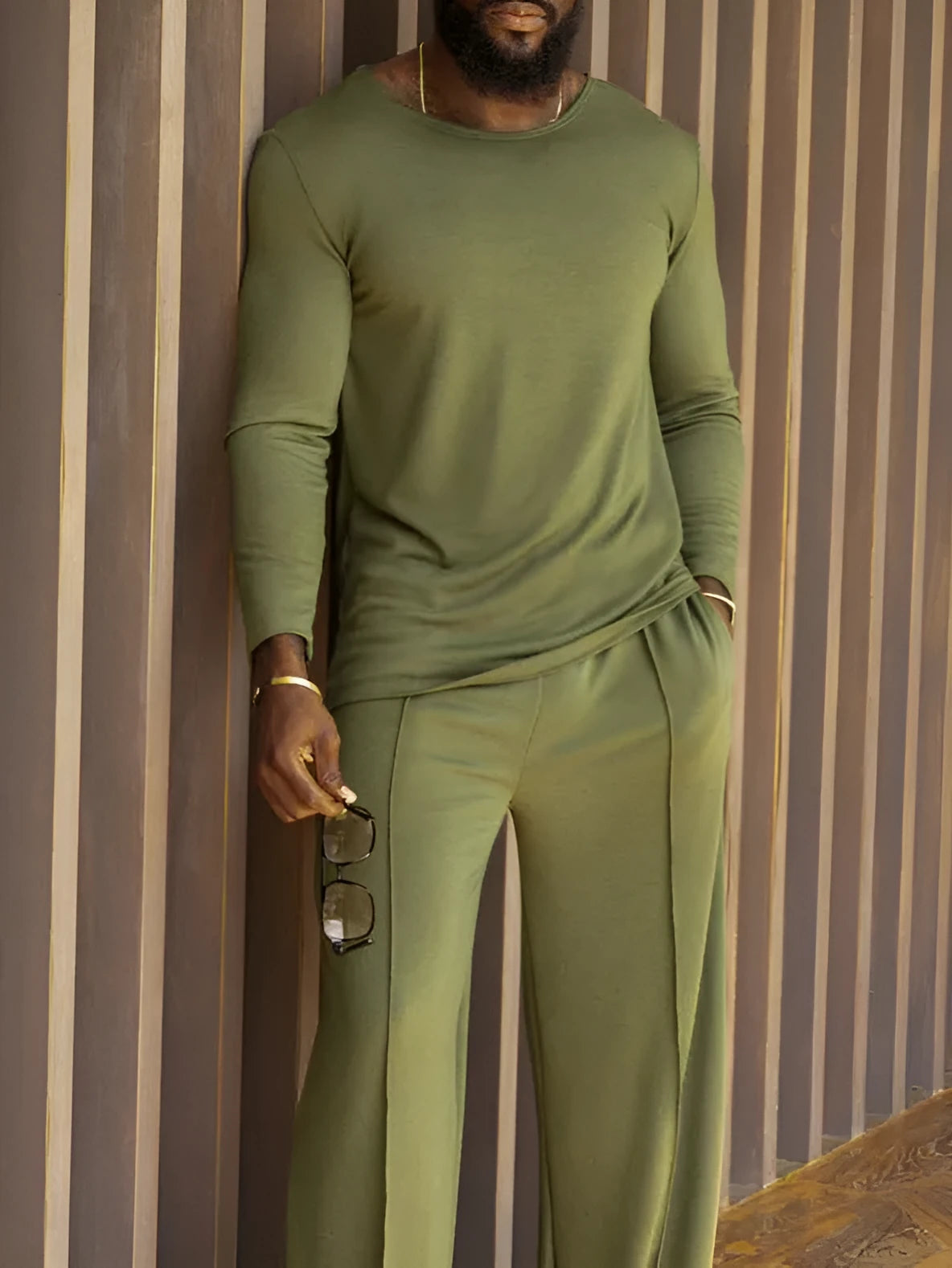Men's green polyester casual set with long sleeve top and full-length trousers on hanger