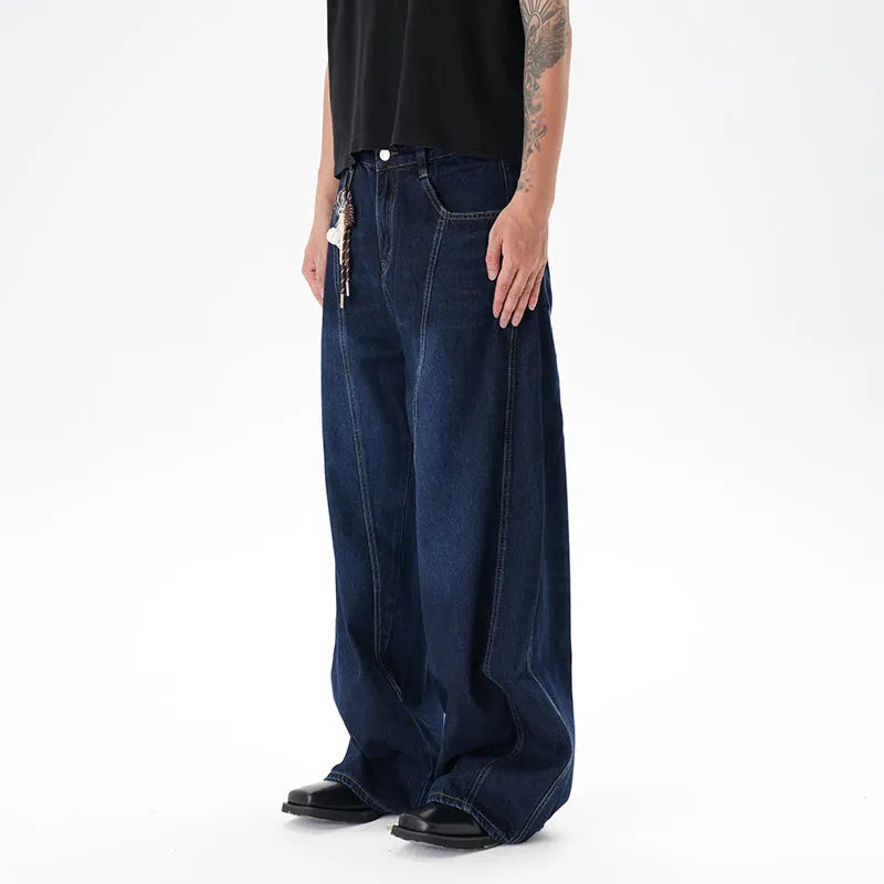 Dark blue wide leg women's jeans with a machete cut and distressed detailing on denim fabric.
