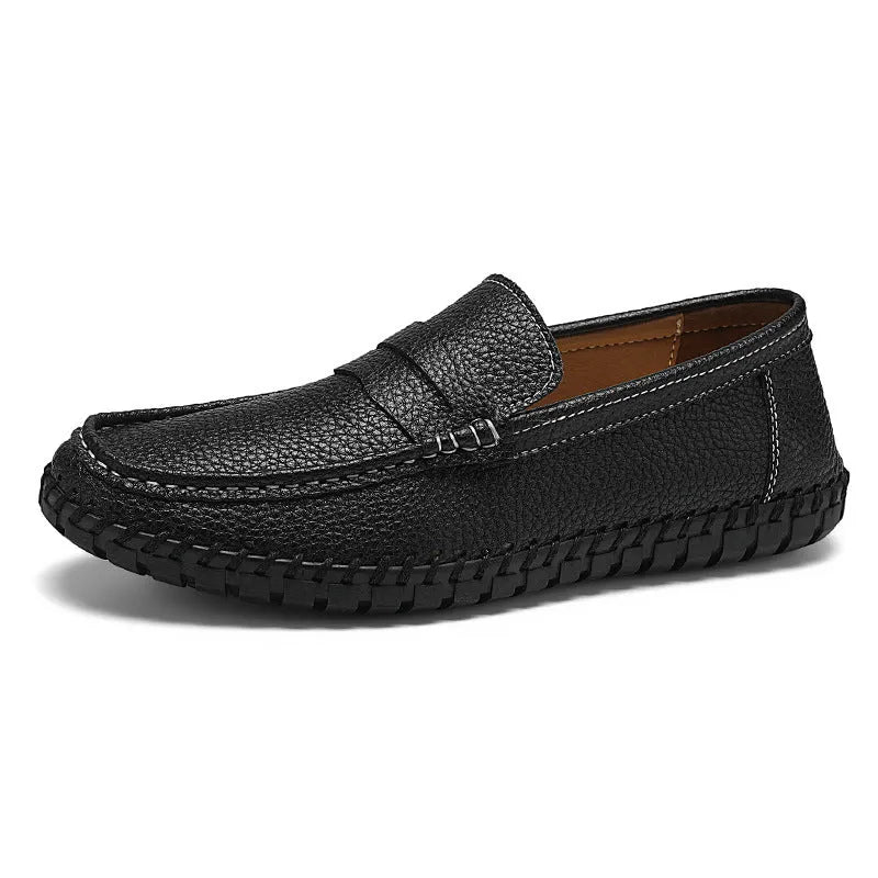 Men's casual leather slip-on shoes with hand-stitched bottom, square heel, and rubber sole in a neutral colour.