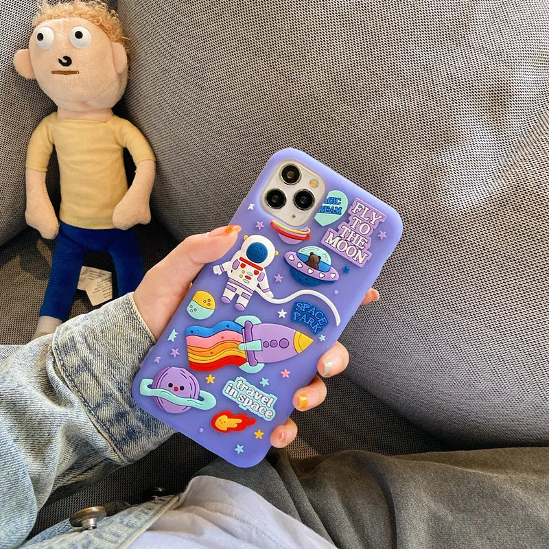 Purple silicone iPhone case with a cartoon astronaut design, shown fitted on a phone.