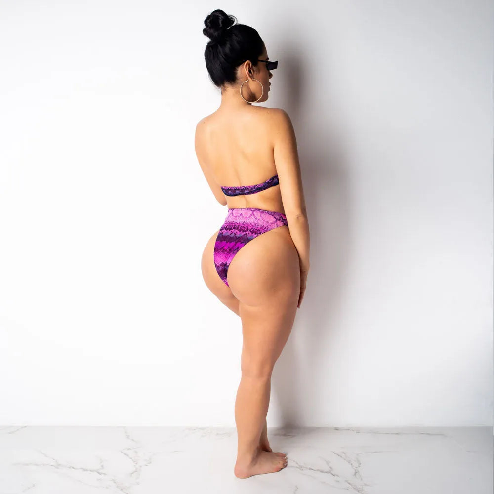 Women's purple snakeskin print bikini set with sleeveless top and shorts on a mannequin.