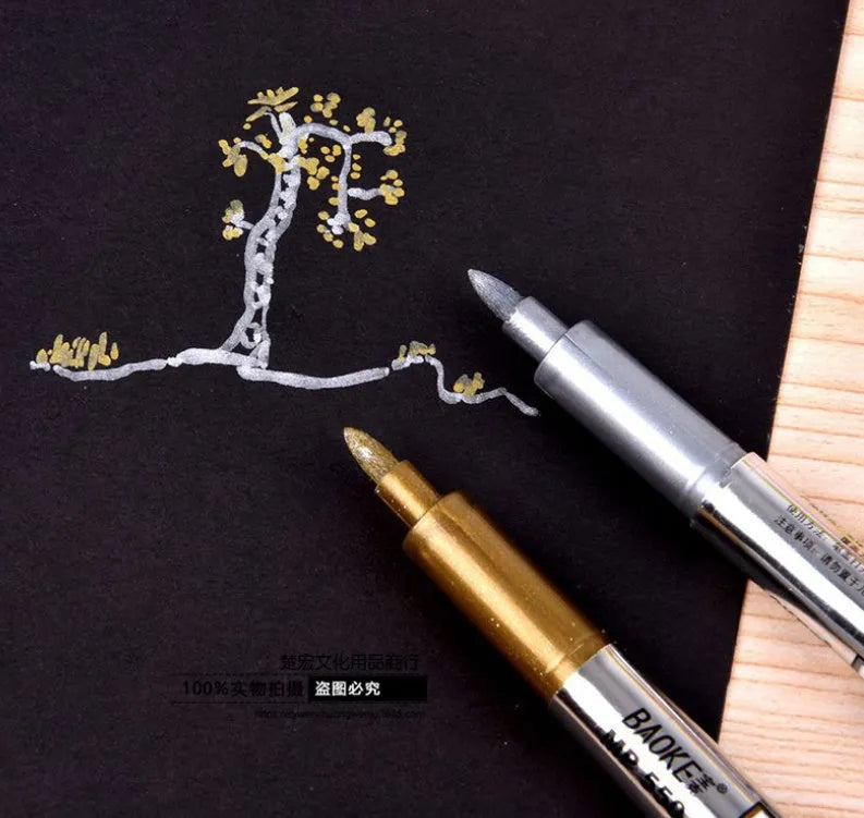 Set of two metallic marker pens: one gold and one silver, with bullet tips on white background