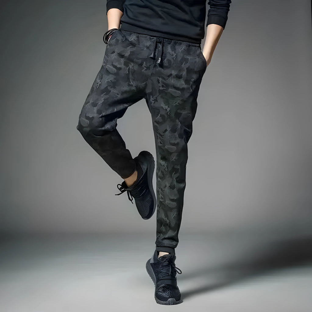 Men's black jogging pants made from acetate and modal fabric, side view on model