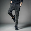 Men's black jogging pants made from acetate and modal fabric, side view on model