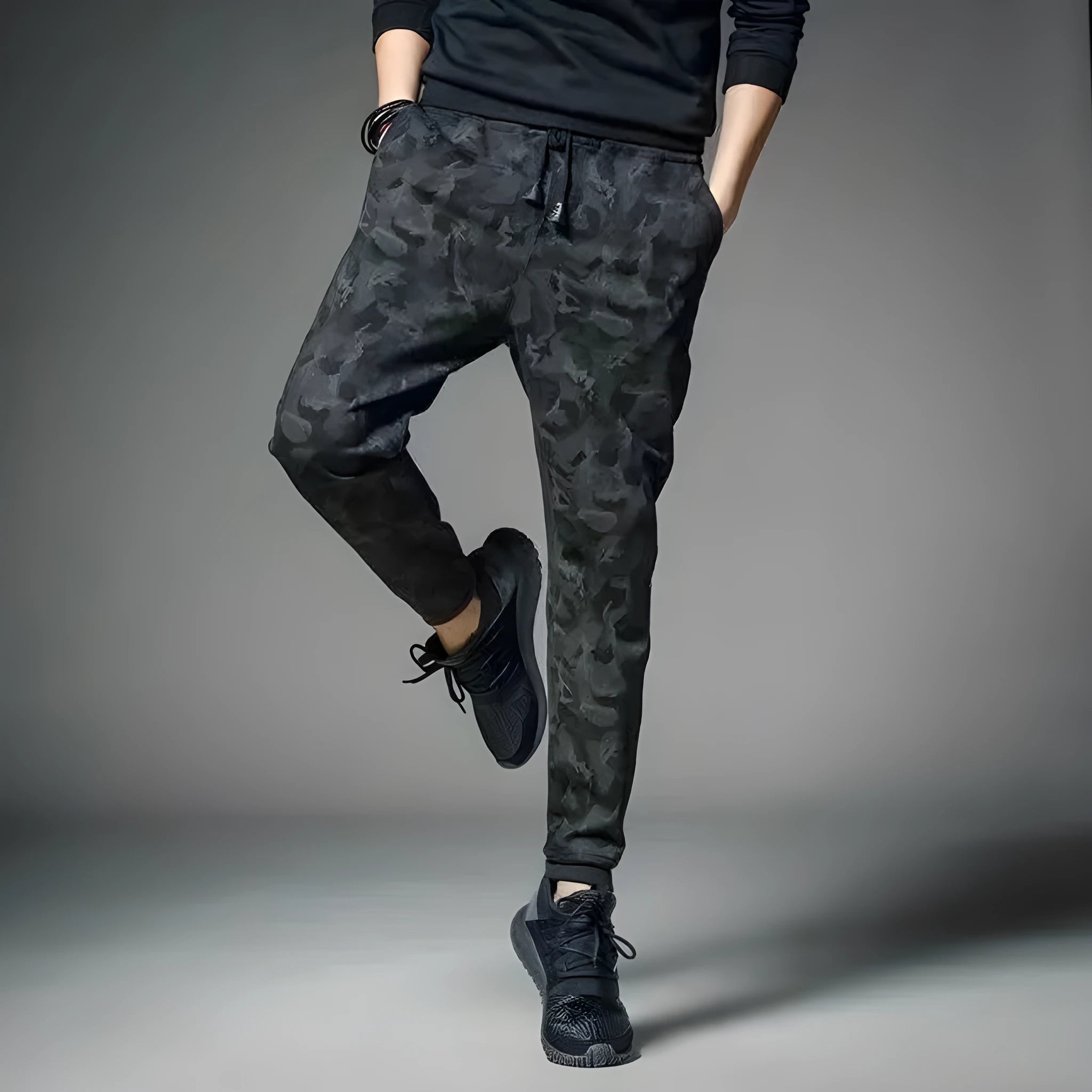 Men's black jogging pants made from acetate and modal fabric, side view on model