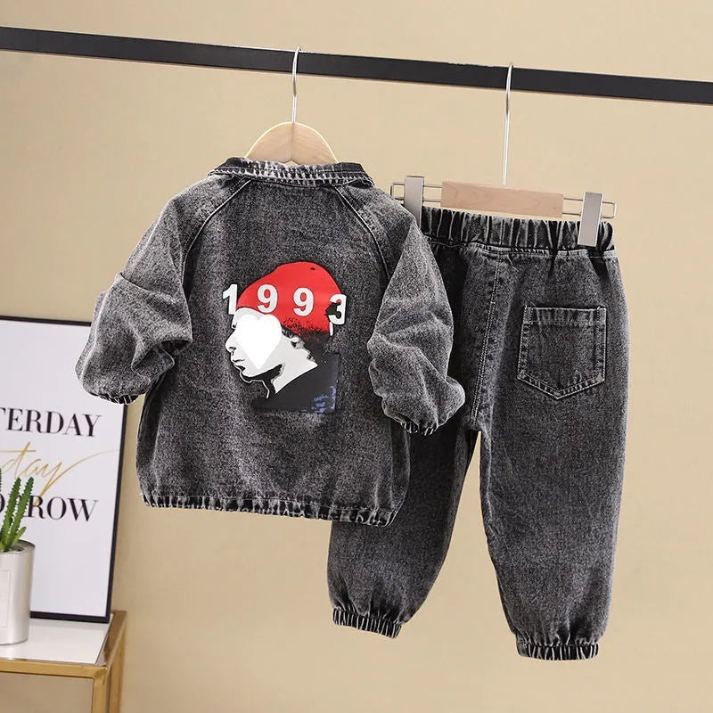 Boys' black denim two-piece suit with long sleeves, shown on a hanger.