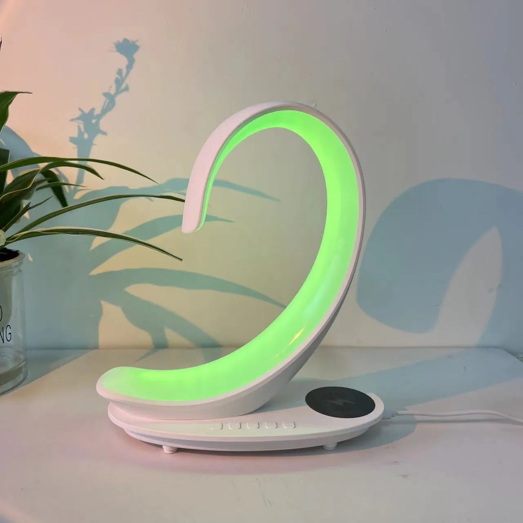 White swan-shaped desk lamp with wireless charging pad and Bluetooth speaker providing colourful ambient lighting