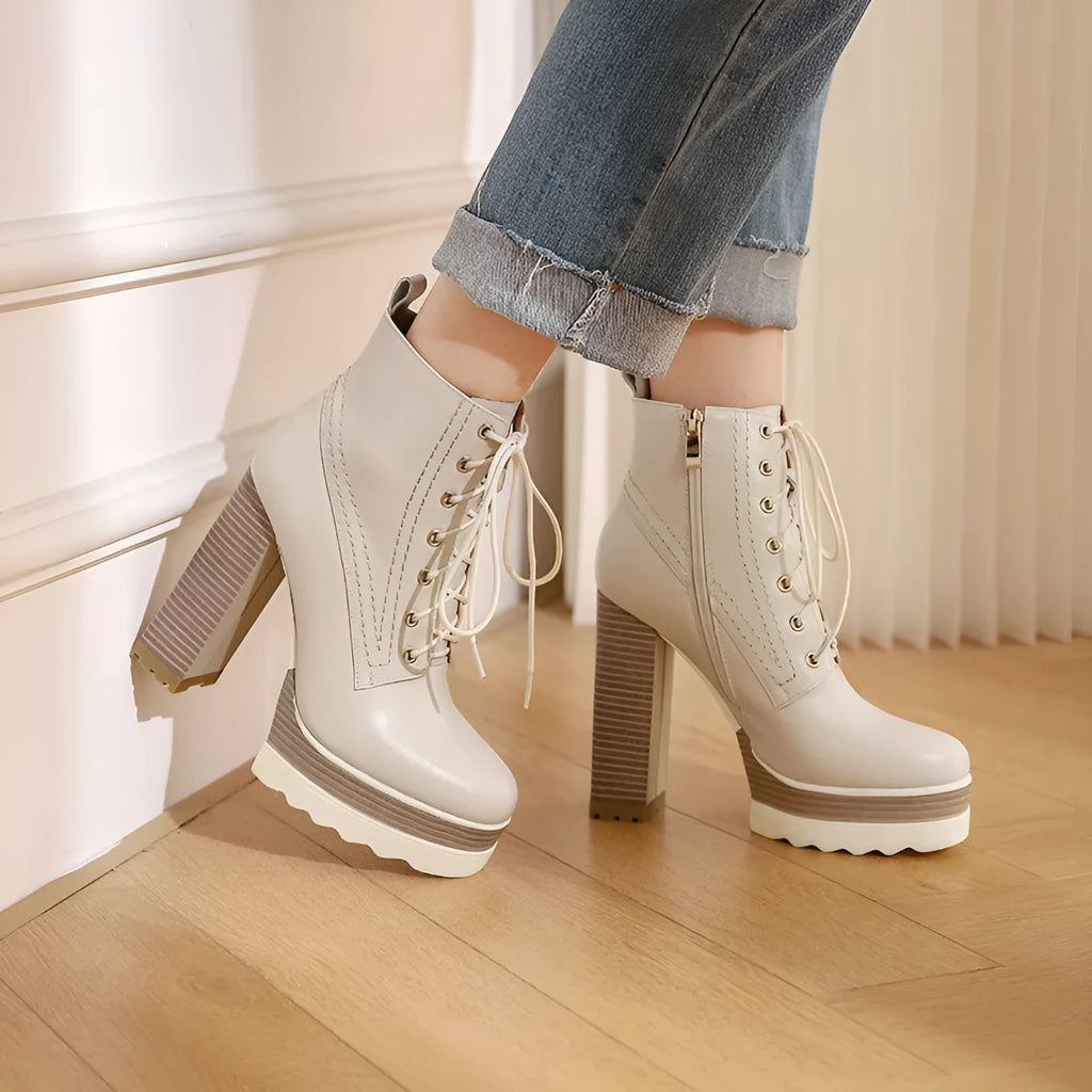 Women's black waterproof platform high heel boots with a chunky block heel and side zip.