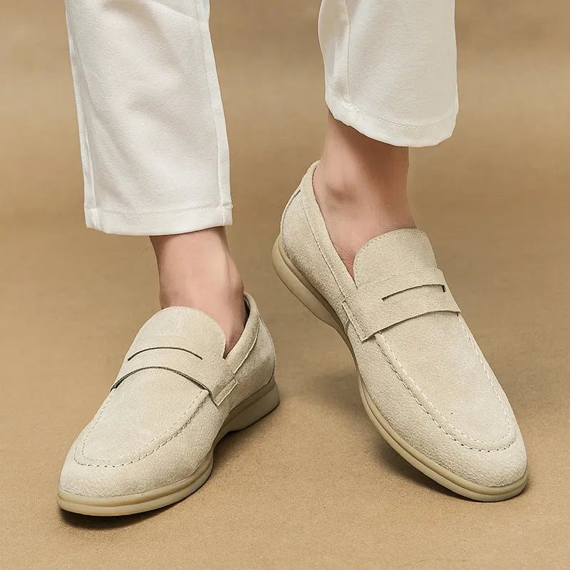 Men's beige leather slip-on casual shoes with a round toe and rubber sole on a white background.