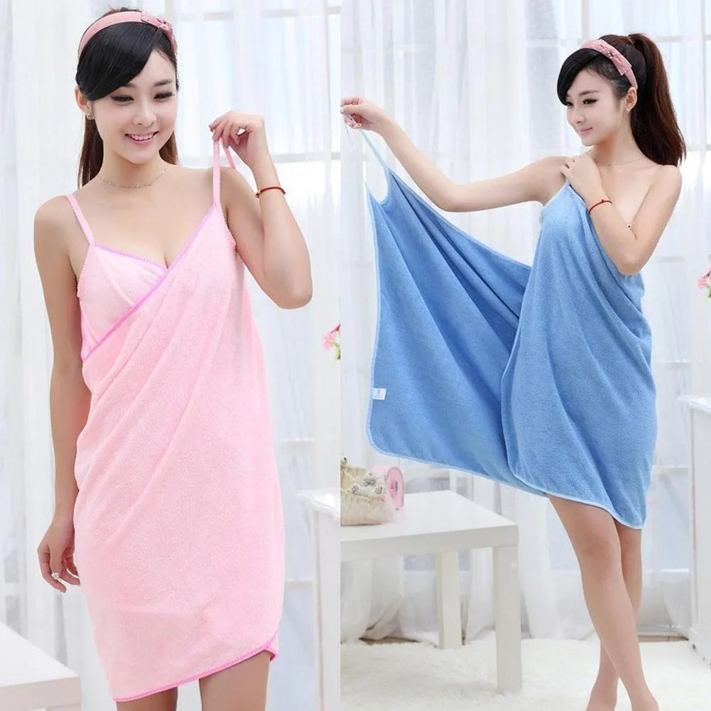 A person wearing a pink beach towel dress at the poolside, demonstrating its use as a cover-up.