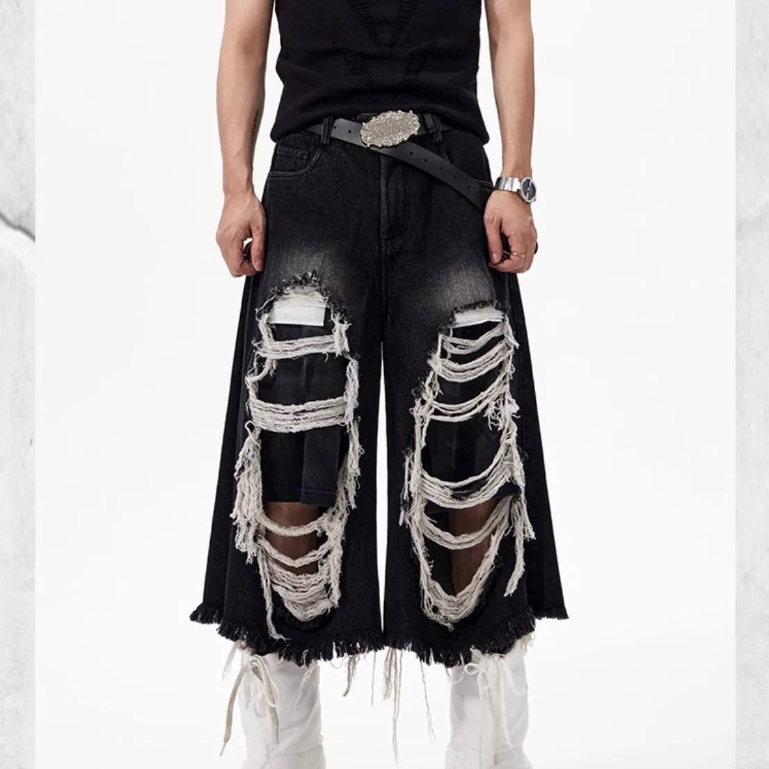 Black women's cropped wide-leg jeans with ripped patch detail on mid-high waist.