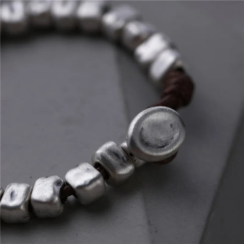 Handmade women's bracelet with silver squares and wooden beads on elastic cord
