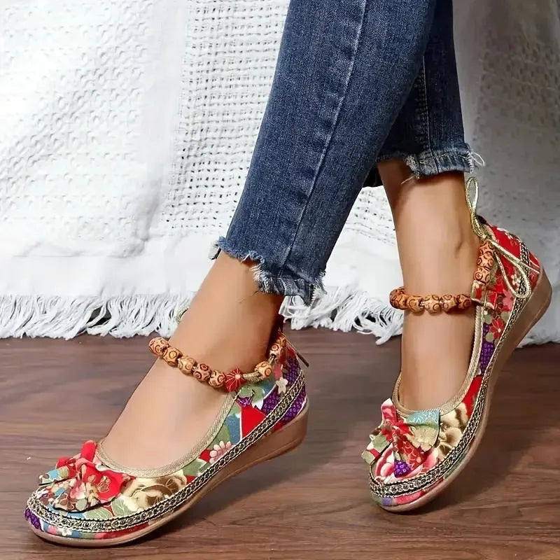 Women's black plus-size ethnic platform sandals with cloth upper and elastic band strap.