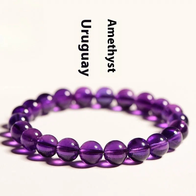 Natural amethyst scattered beads Uruguay bracelet in polished crystal on a white background.