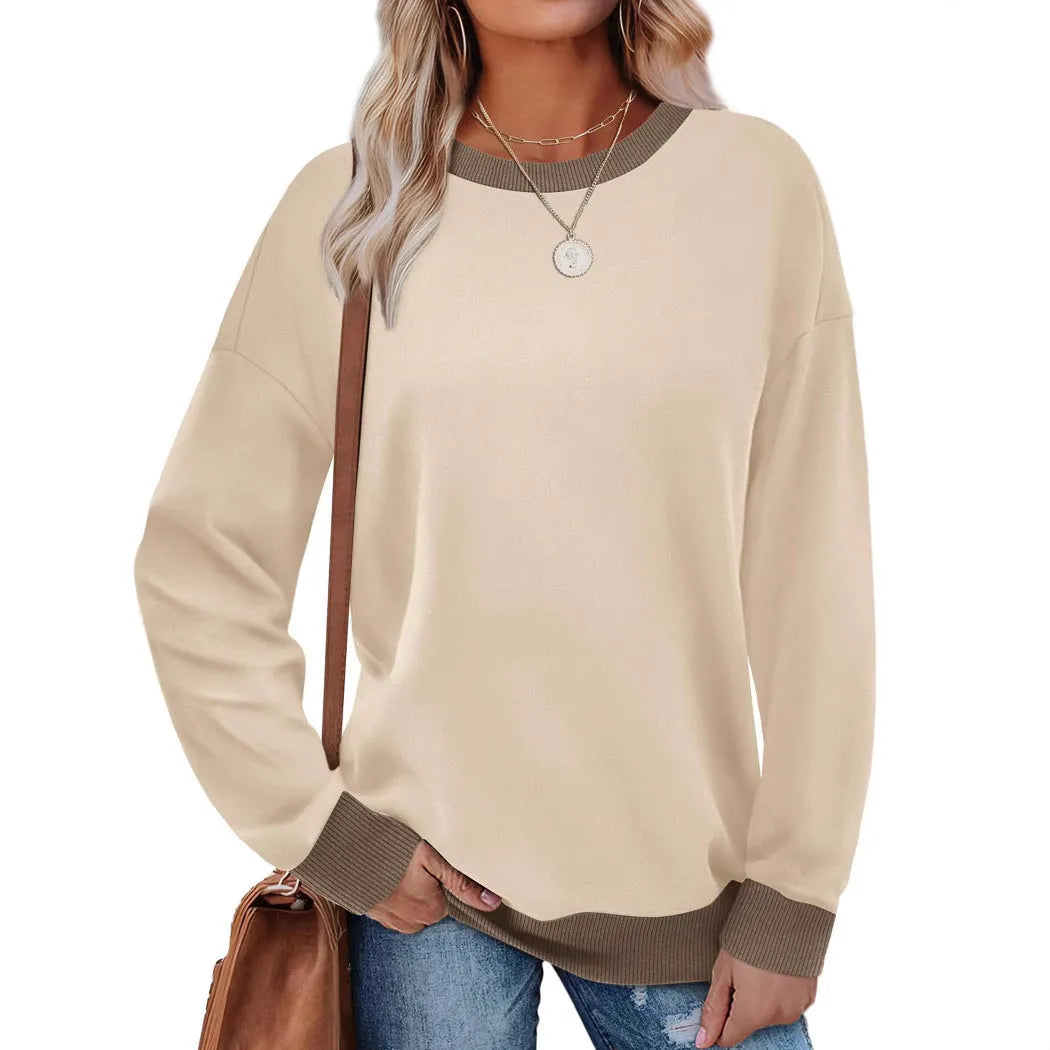 Woman wearing a loose-fitting, long-sleeved striped top with a round neckline in a choice of seven colours.