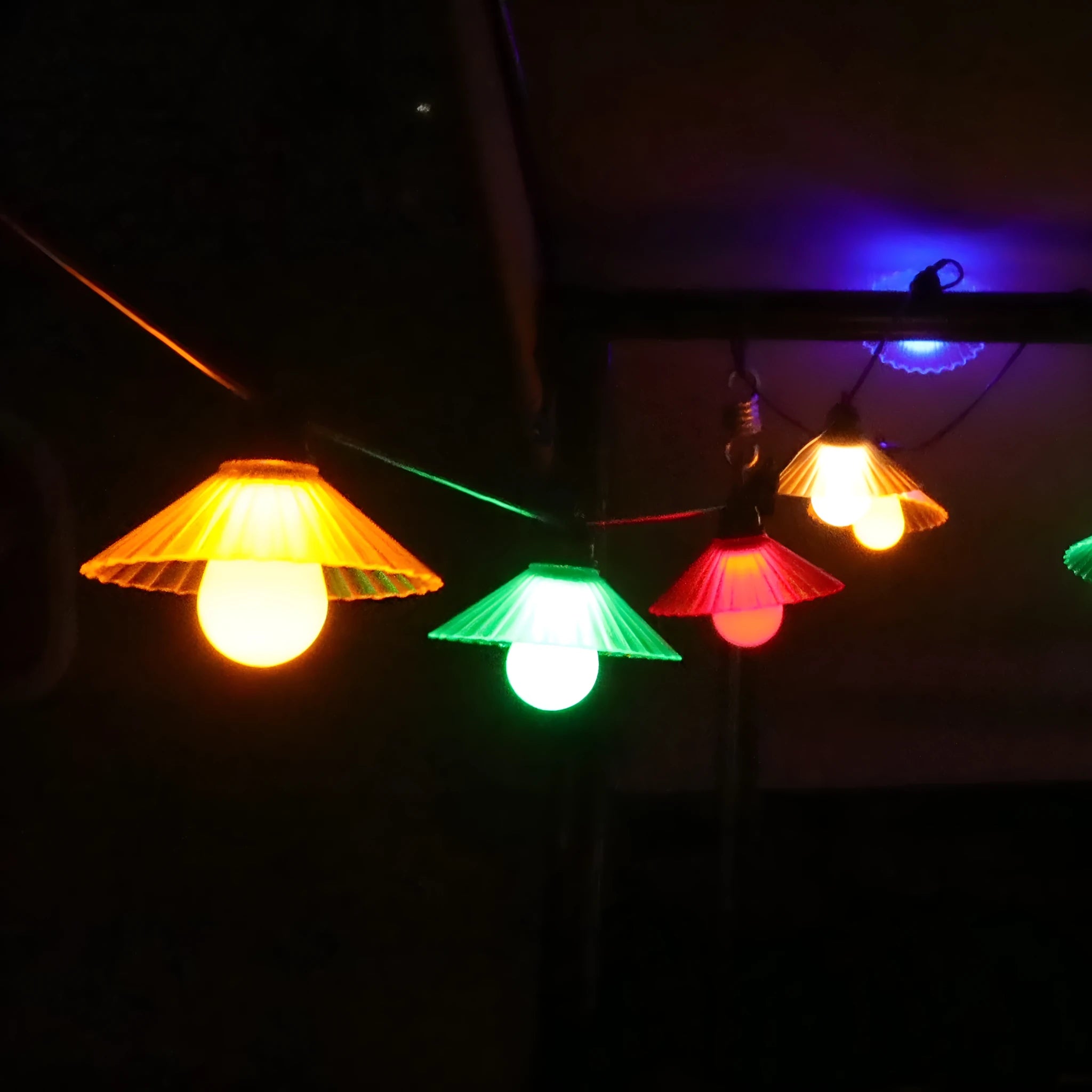 Outdoor LED string lights with flower-shaped bulbs in four colours or warm white, IP65 rated.