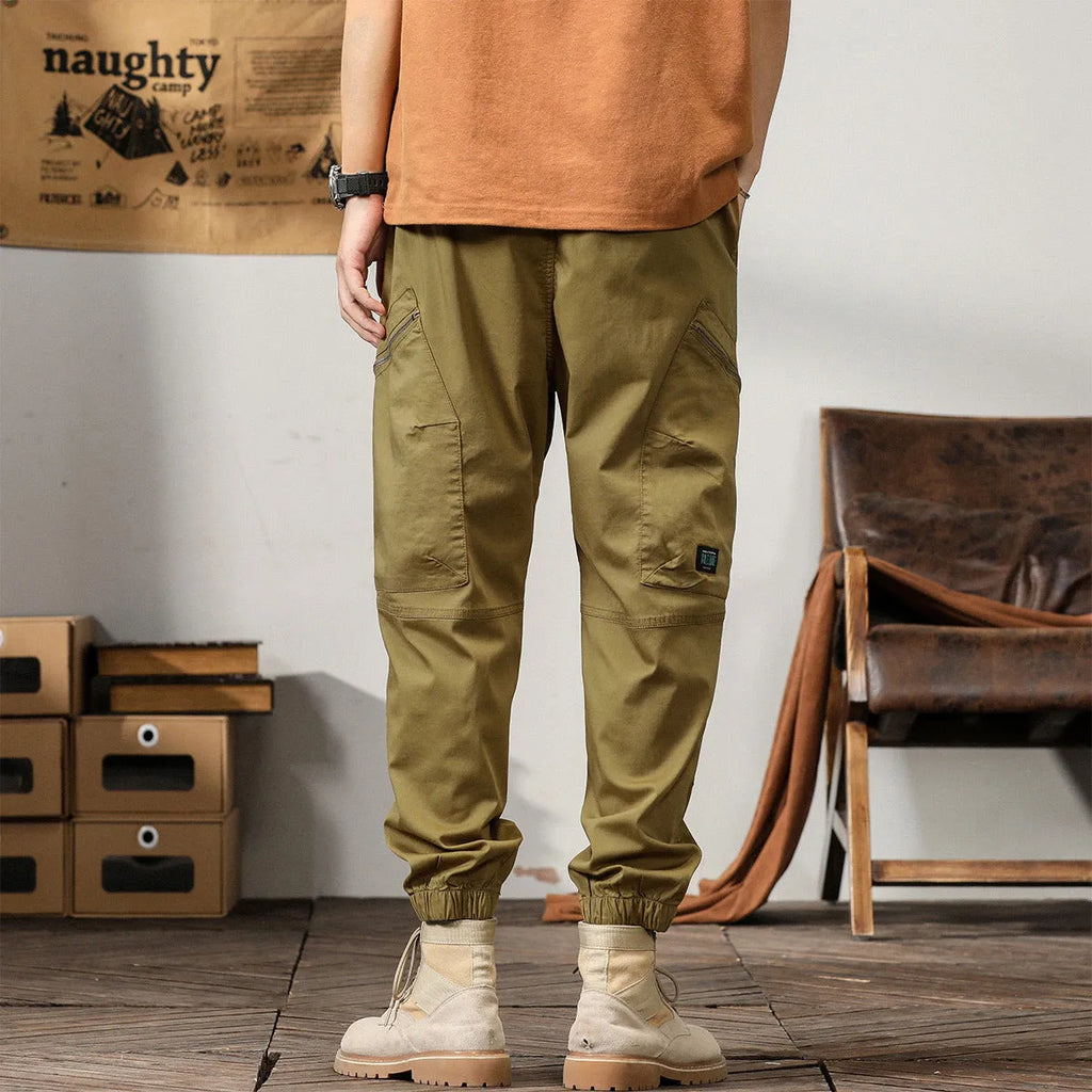 Men's cotton tapered harem trousers in black with elastic waistband and ankle band detailing
